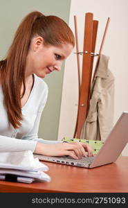 Young business woman working at office with laptop