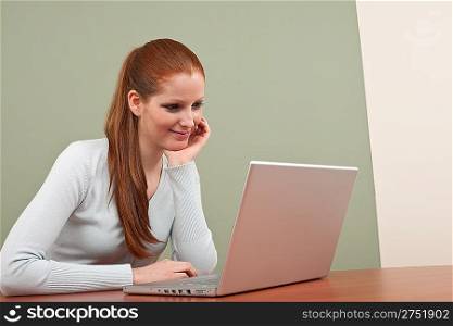 Young business woman working at office with laptop