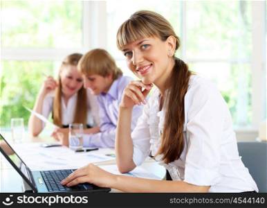 young business woman working in office with collegues on background