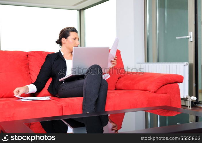 young business woman working on laptop at home in confort bright apartment