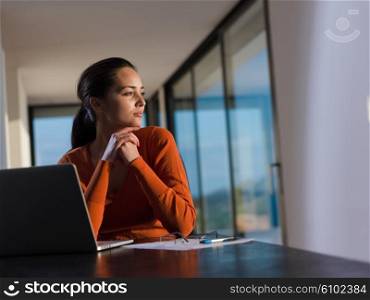 young business woman working on laptop computer at modern home office