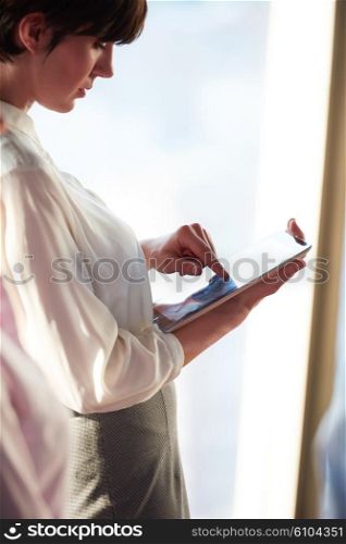 young business woman working on tablet computer at office
