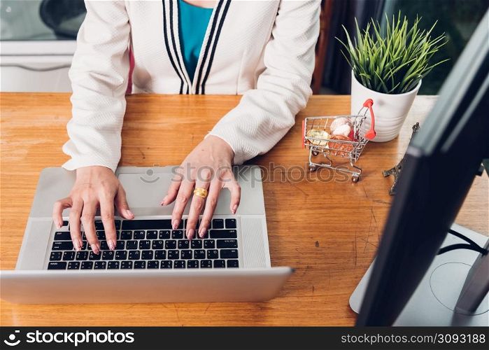 Young business woman working typing laptop computer on desk office