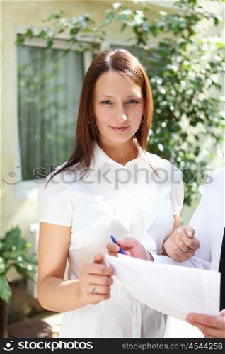 young business woman working with documents outdoors