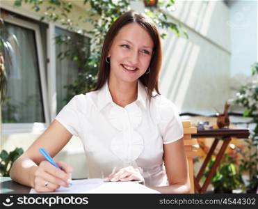 young business woman working with documents outdoors