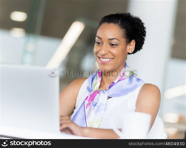 Young business woman working with laptop in office