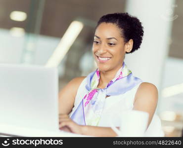 Young business woman working with laptop in office