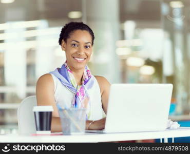 Young business woman working with laptop in office