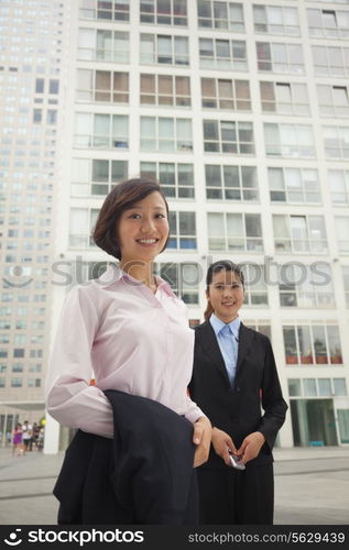 Young business women standing outside of CBD, portrait