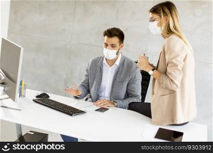 Young business workers wear masks to protect and take care of their health in the office