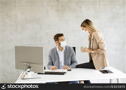 Young business workers wear masks to protect and take care of their health in the office