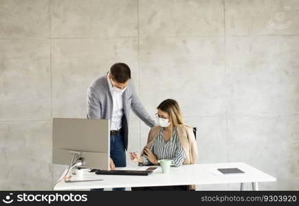 Young business workers wear masks to protect and take care of their health while working on computer