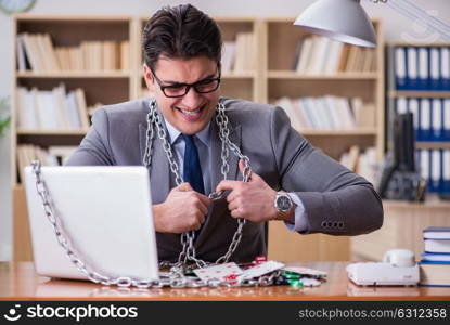 Young businessman addicted to online gambling cards playing in t. Young businessman addicted to online gambling cards playing in the office