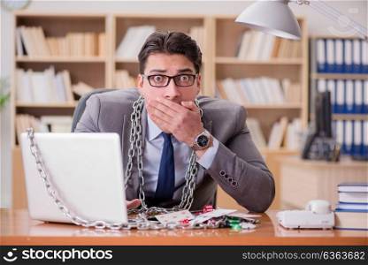 Young businessman addicted to online gambling cards playing in t. Young businessman addicted to online gambling cards playing in the office
