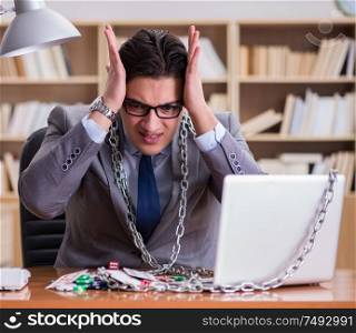 Young businessman addicted to online gambling cards playing in the office. Young businessman addicted to online gambling cards playing in t