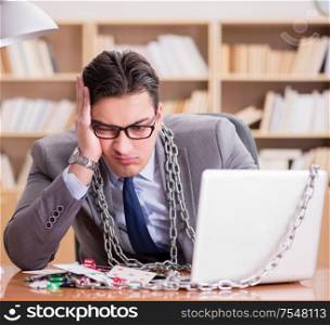 Young businessman addicted to online gambling cards playing in the office. Young businessman addicted to online gambling cards playing in t