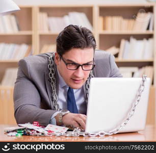 Young businessman addicted to online gambling cards playing in the office. Young businessman addicted to online gambling cards playing in t