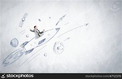 Young businessman,an flying in sky on drawn rocket