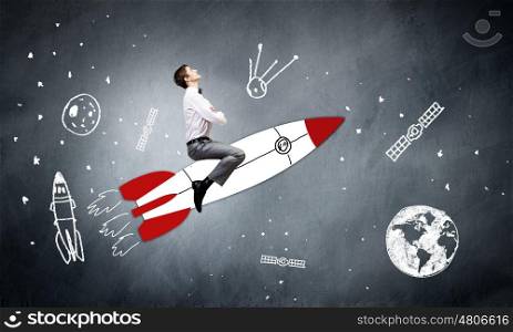 Young businessman,an flying in sky on drawn rocket