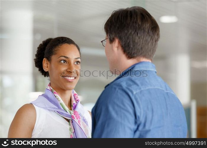 Young businessman and businesswoman shaking hands