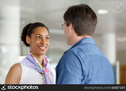 Young businessman and businesswoman shaking hands