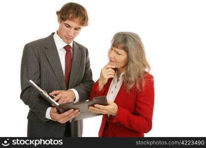 Young businessman and older female boss going over a report together. Isolated on white.