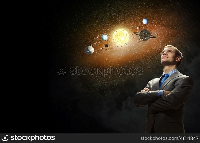 Young businessman and planets of sun system. Mysteries of space