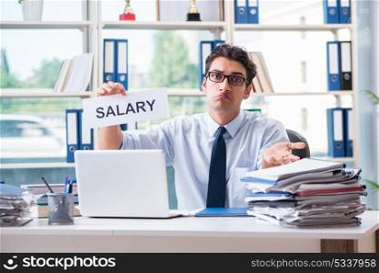 Young businessman asking for salary increase in office