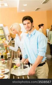 Young businessman at cafeteria hold serving tray canteen self-service