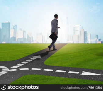 Young businessman at crossroads in uncertainty concept. The young businessman at crossroads in uncertainty concept