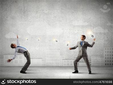 Young businessman benting from thrown light bulb