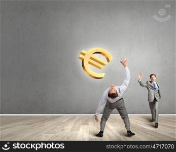 Young businessman benting to evade from thrown euro sign. Money concept