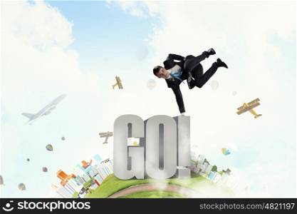 Young businessman breakdancer. Active businessman making handstand on word go