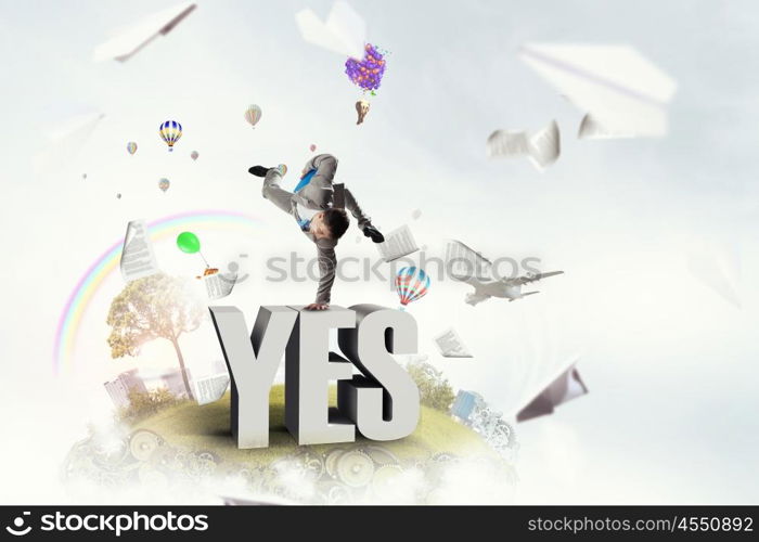 Young businessman breakdancer. Active businessman making handstand on word yes