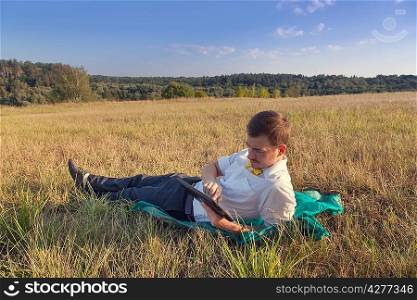 Young businessman browsing in Internet on pad outdoor