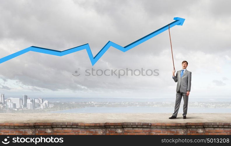 Young businessman caught increasing graph with lead. Do not let the idea to leave you