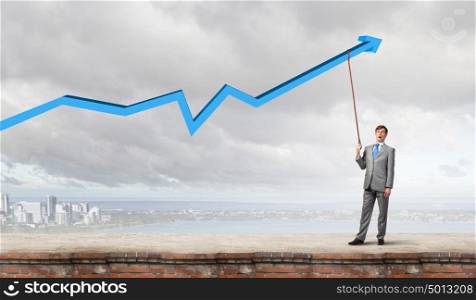 Young businessman caught increasing graph with lead. Do not let the idea to leave you