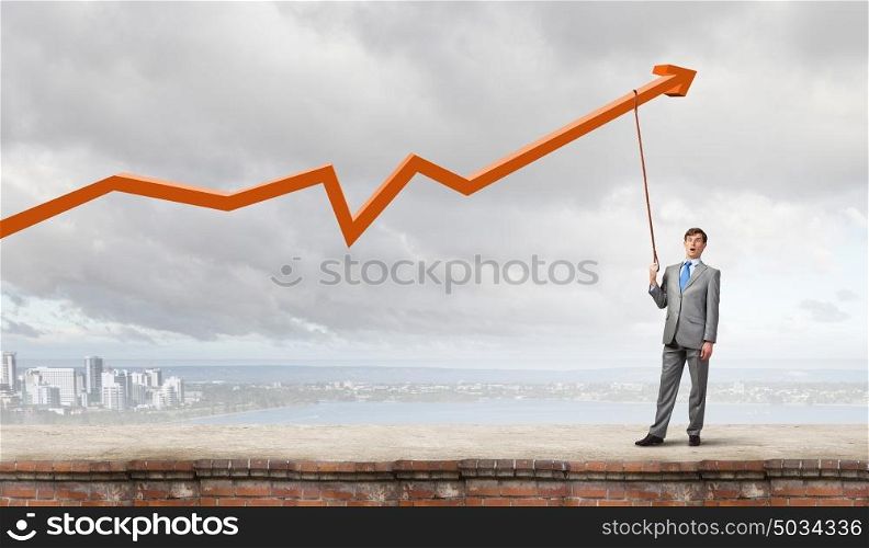 Young businessman caught increasing graph with lead. Do not let the idea to leave you