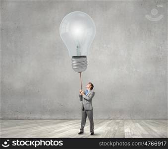 Young businessman caught light bulb on lead. Do not let the idea to leave you