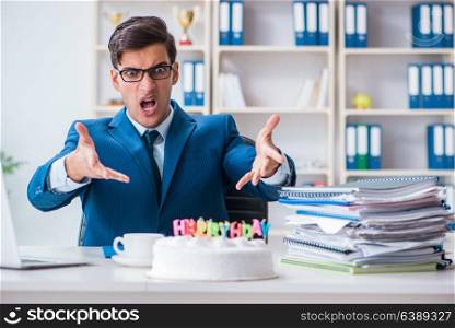 Young businessman celebrating birthday alone in office