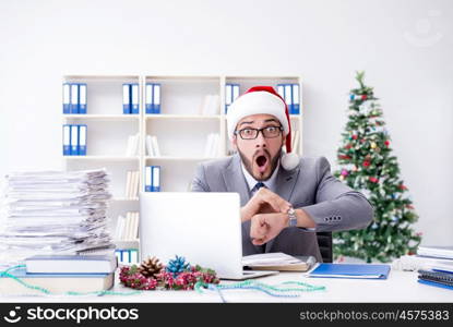 Young businessman celebrating christmas in the office