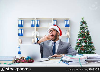 Young businessman celebrating christmas in the office