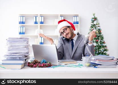 Young businessman celebrating christmas in the office