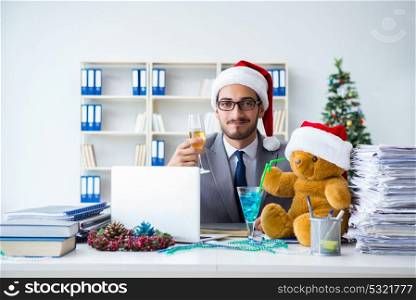 Young businessman celebrating christmas in the office