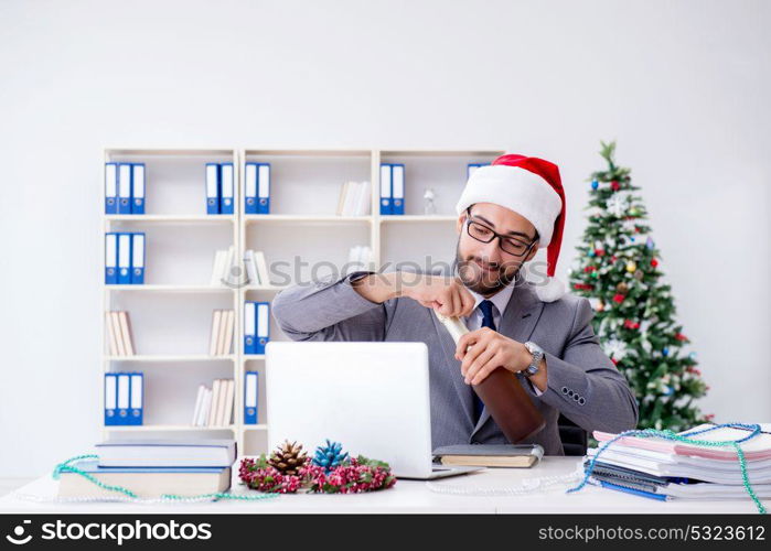 Young businessman celebrating christmas in the office