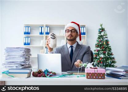 Young businessman celebrating christmas in the office