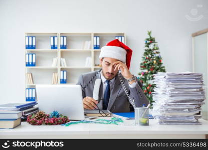 Young businessman celebrating christmas in the office