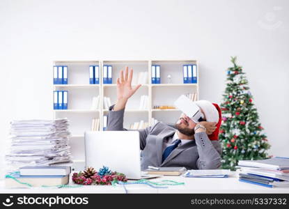 Young businessman celebrating christmas in the office