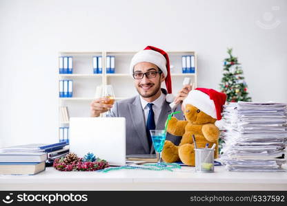 Young businessman celebrating christmas in the office