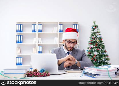 Young businessman celebrating christmas in the office